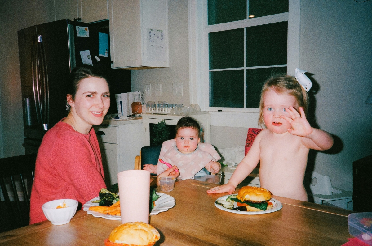 A mom with her kids on a dining table A mom with her kids on a dining table. She is designing her new life with joy
